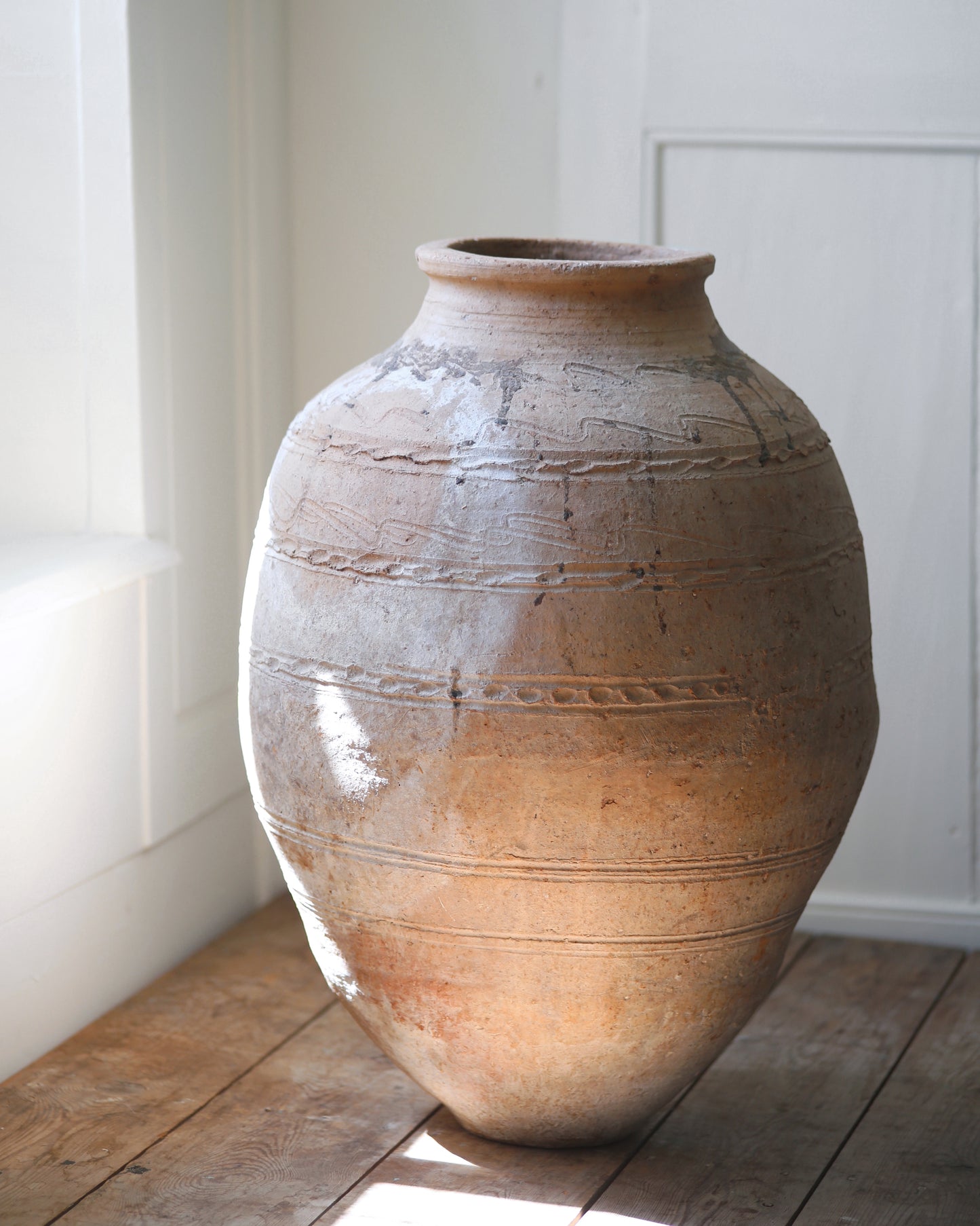 Naturally aged patina of old terracotta olive pot