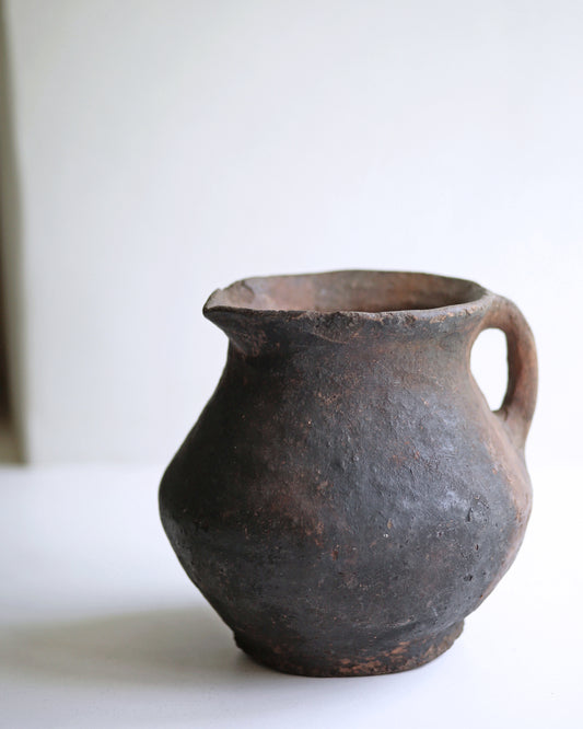 Antique clay pottery jug with hand finished texture