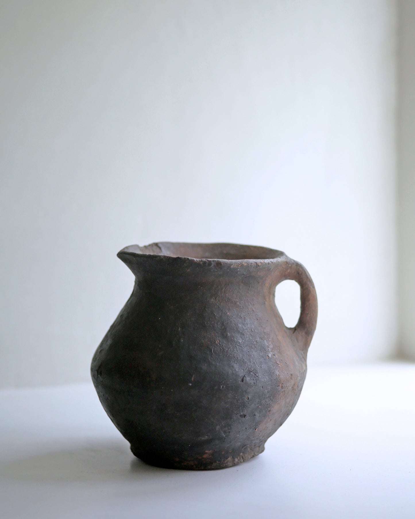 Side profile of sweet decorative rustic earthenware pottery jug