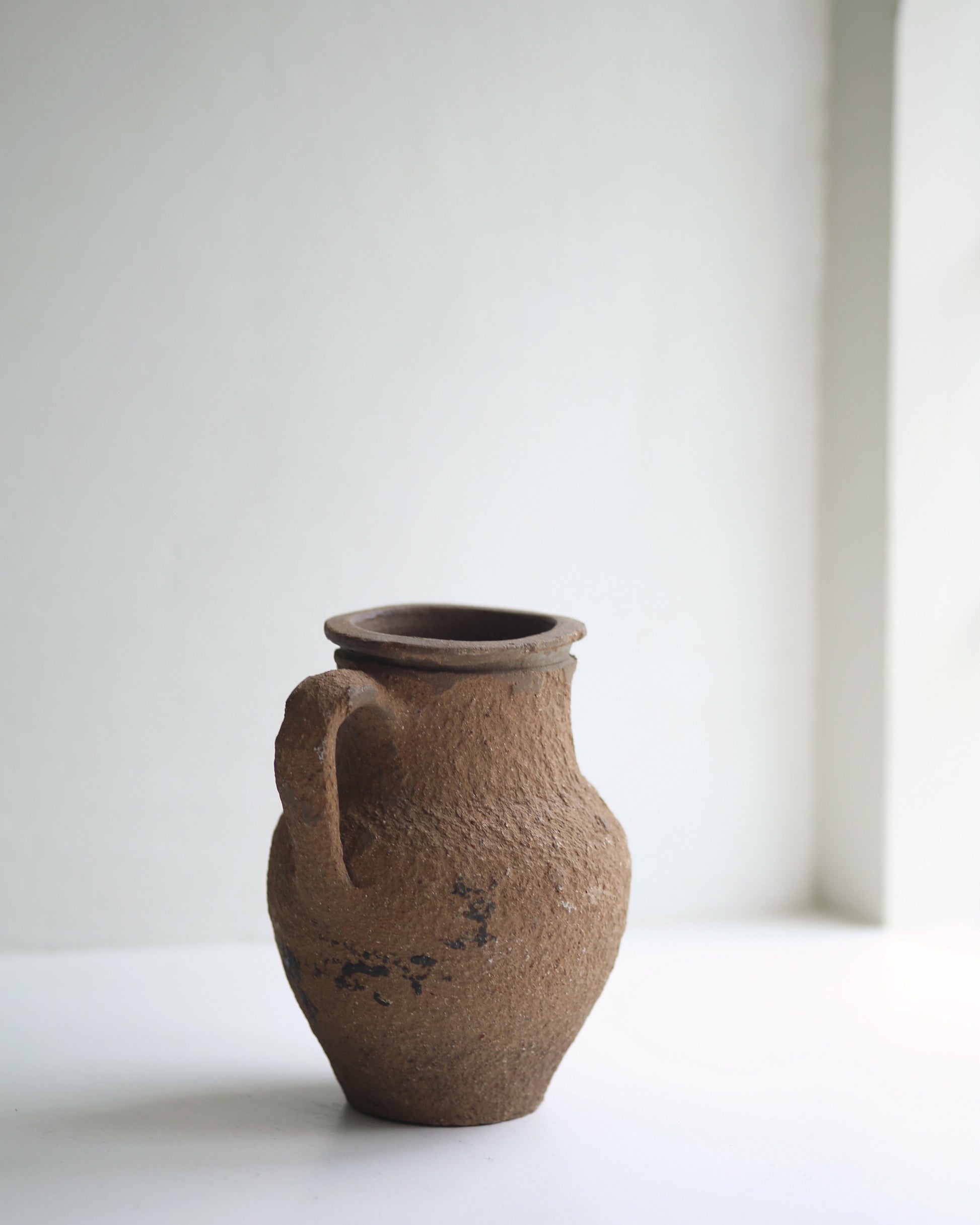 Age worn textured jug for rustic interior decor