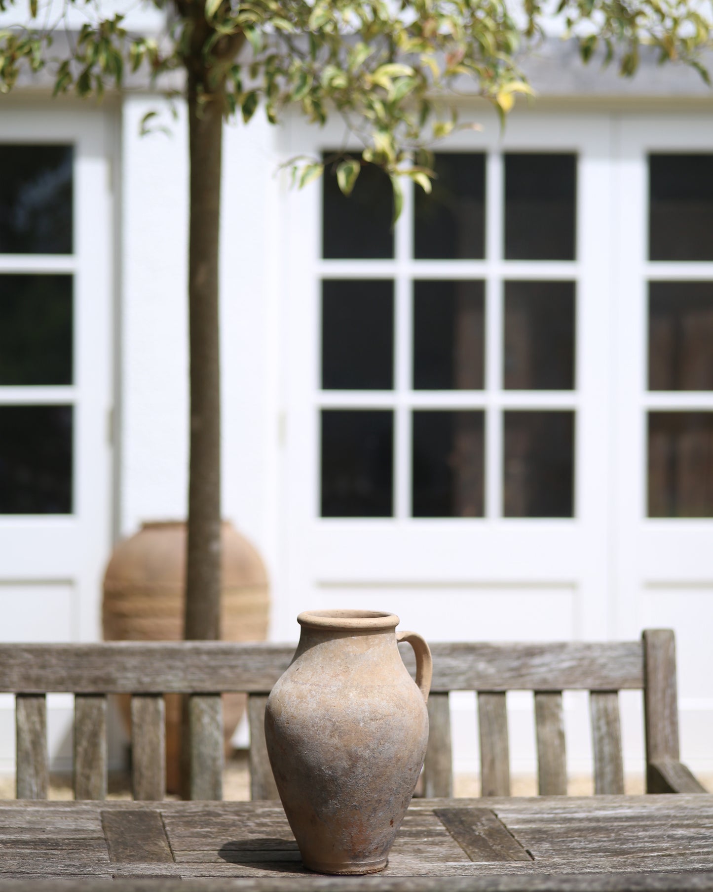 Antique olive pot as garden table centrepiece