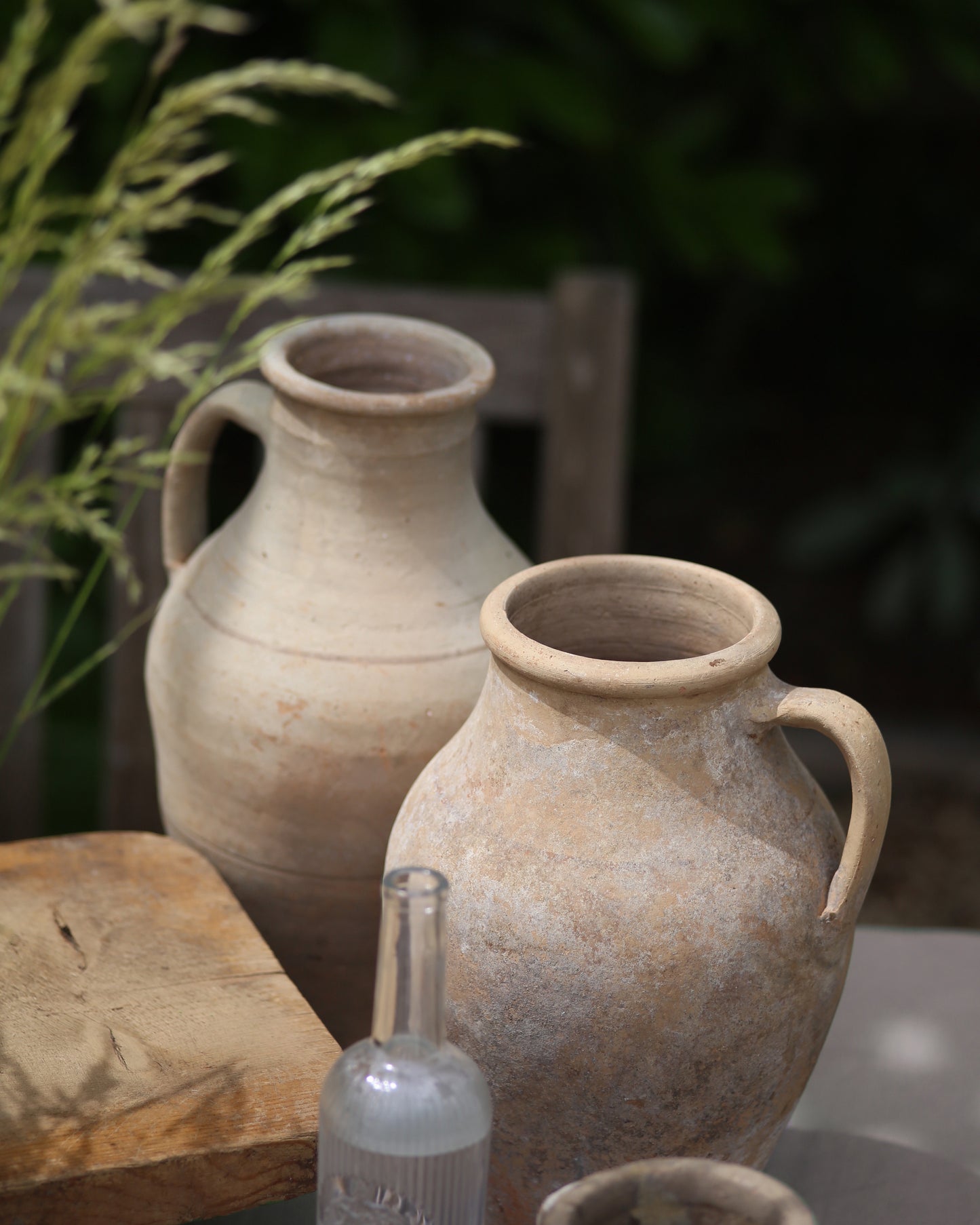 Antique terracotta olive pots used as summer styling al fresco garden dining table