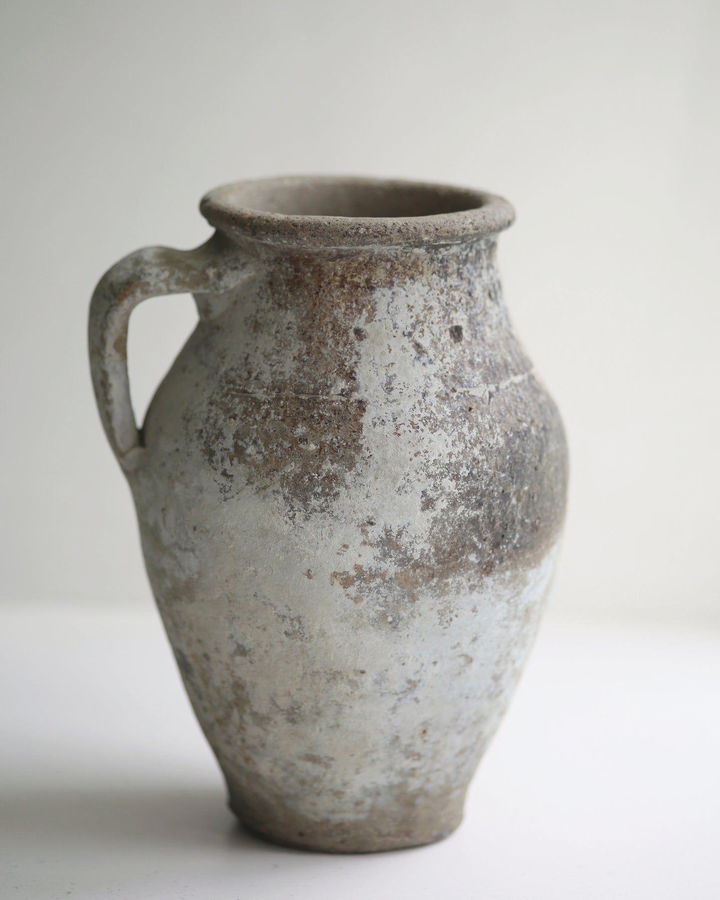 Whitewash patina of Turkish olive pot displayed as decorative piece in window