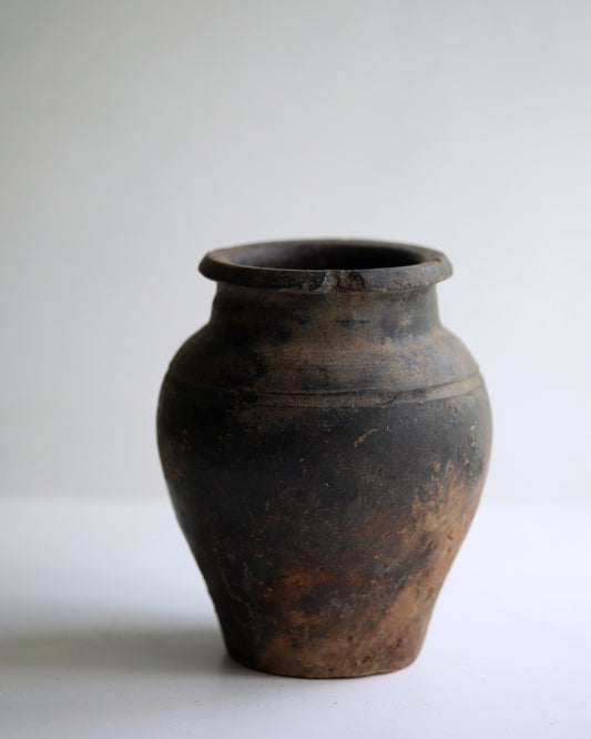 Small antique bud vase made from aged terracotta pottery