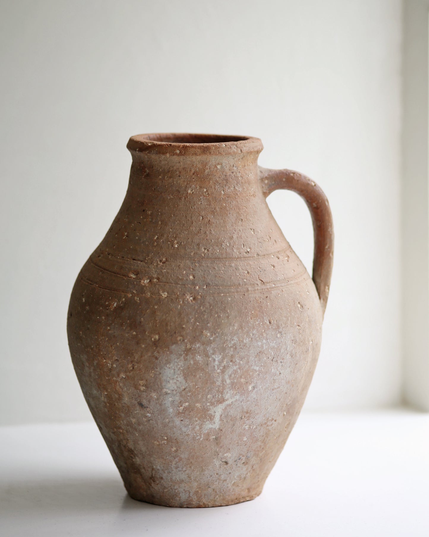 Aged patina and rustic textured terracotta pot