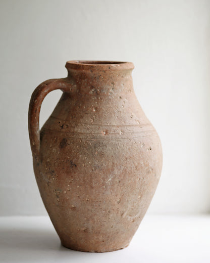 Rustic pitted textured pot as display vase