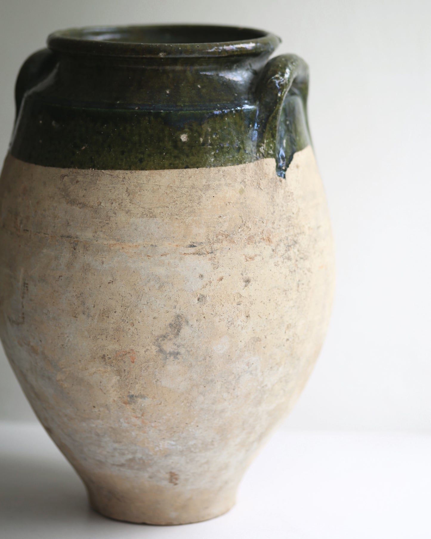 Rustic terracotta pot displayed in sunny window sill