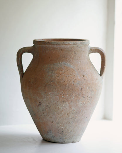 Aged patina finish of rustic textured pottery for the home displayed in sunny window sill