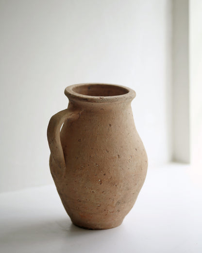 Rustic textured terracotta pot to use as decorative vase