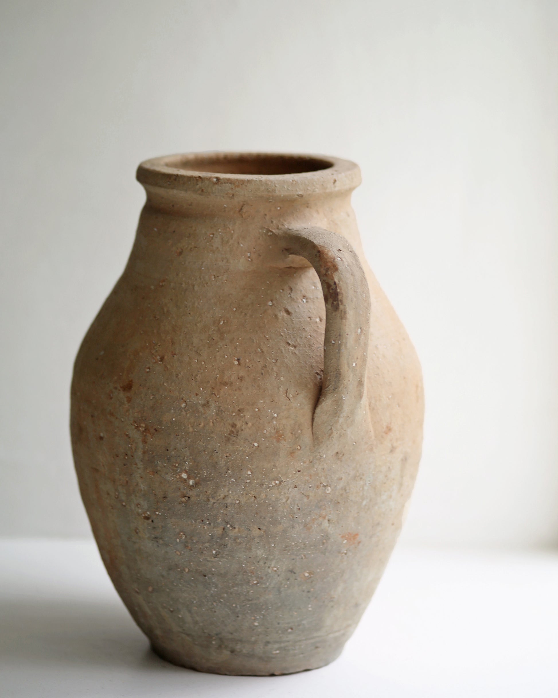 Rustic aged vintage clay pottery shown as decorative window display