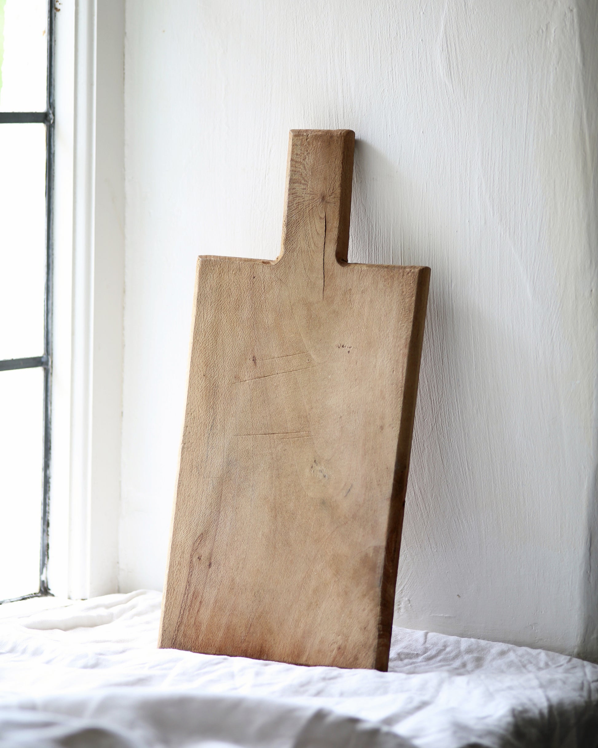 Unique rustic pale wooden bread board for display