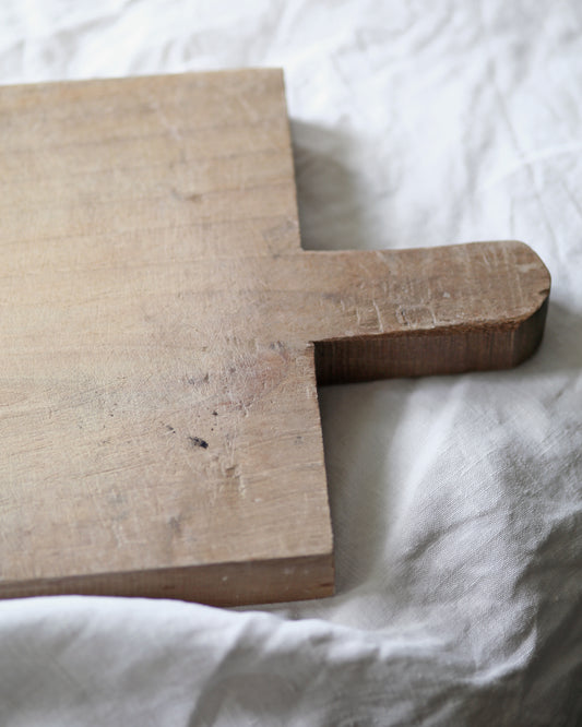 Pale wooden rustic chopping board with signs of age