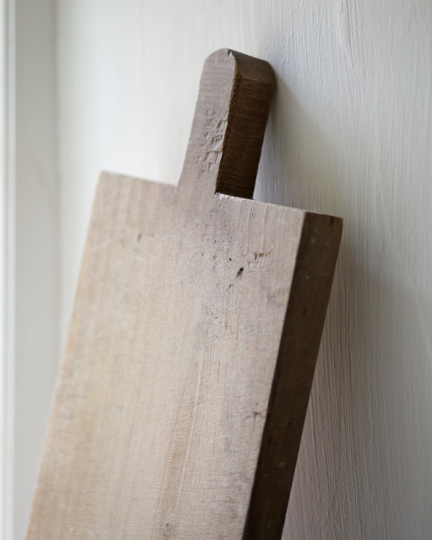 Close up of rustic wooden handle of chopping board