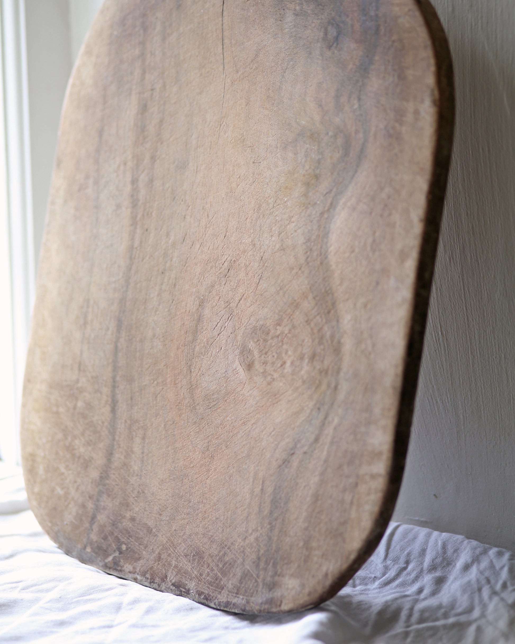 Beautiful grain and signs of previous ware on antique wooden bread board