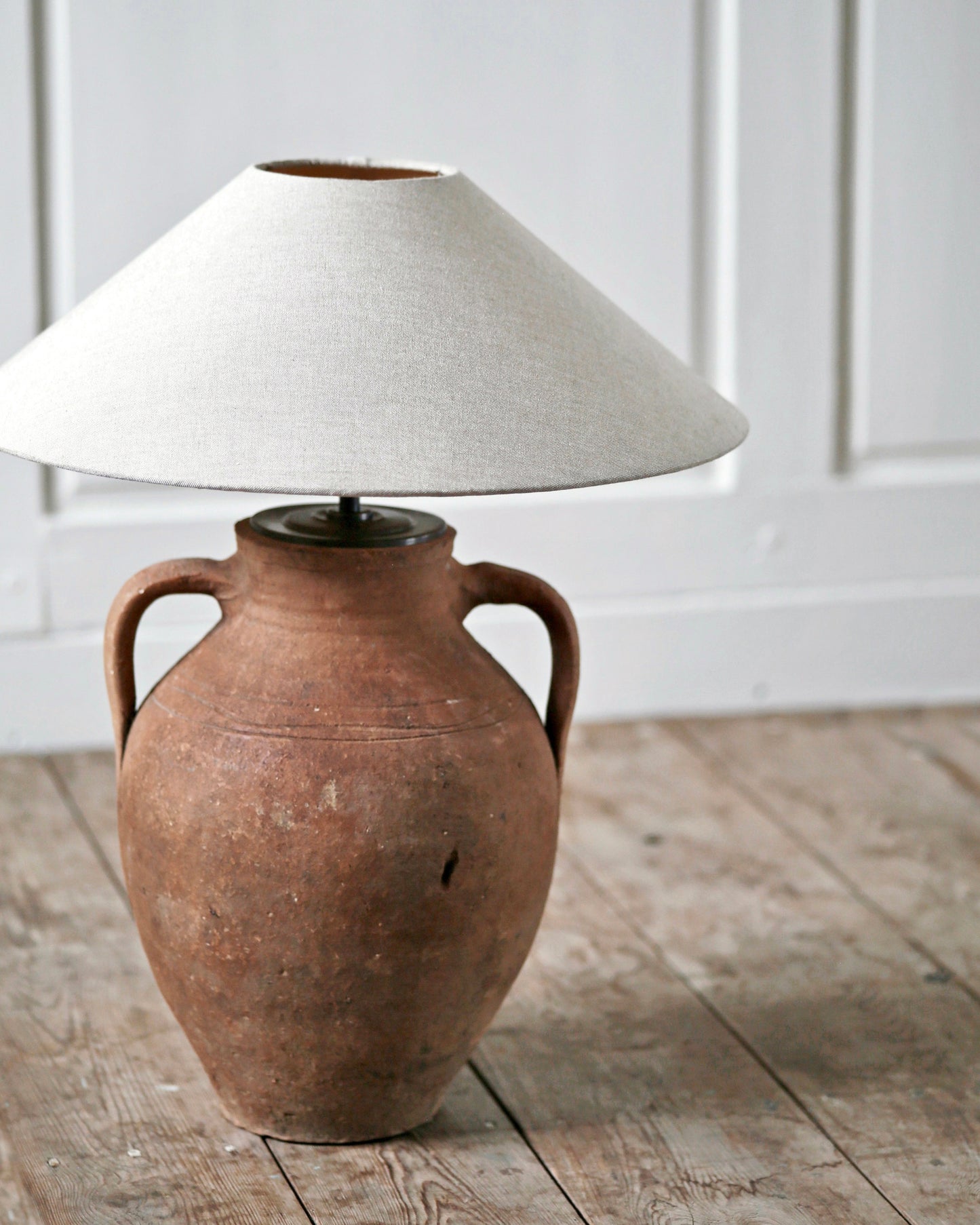 Antique amphora lamp with brass fittings and linen lampshade