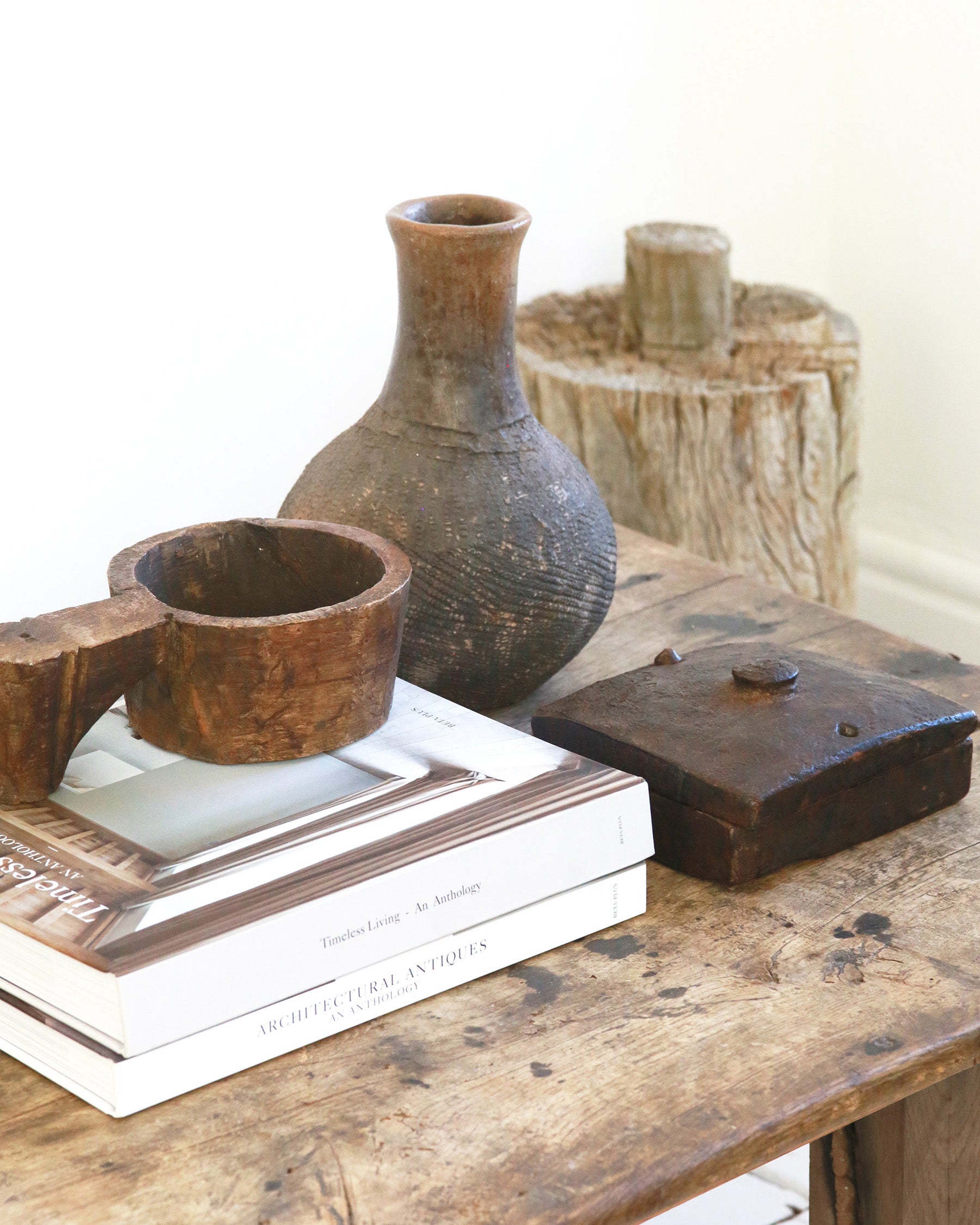 Coffee table styling of antique wooden accessories and textured vase