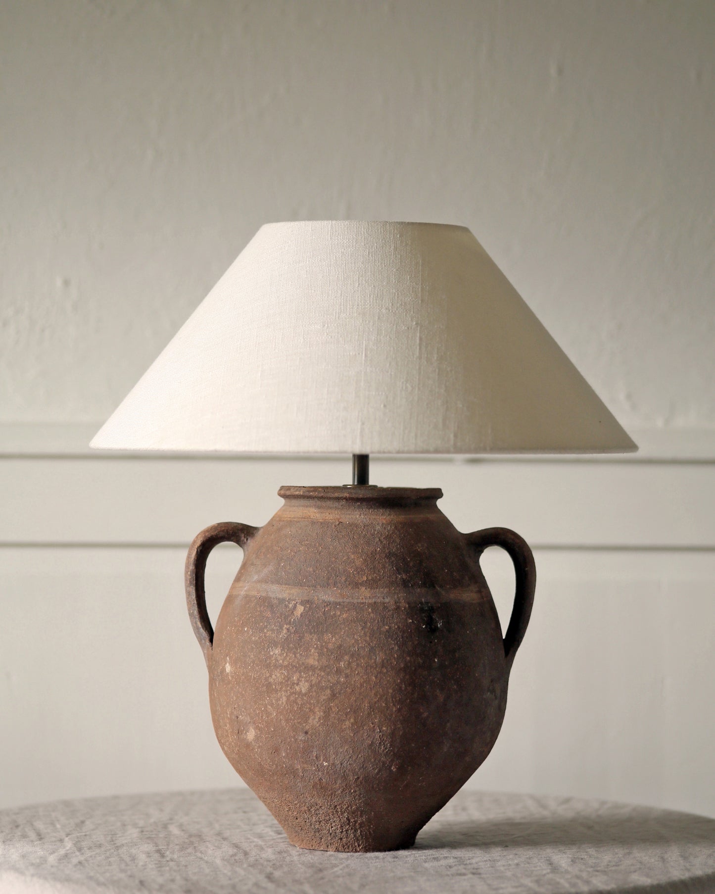 Antique amphora with handles converted to table lamp