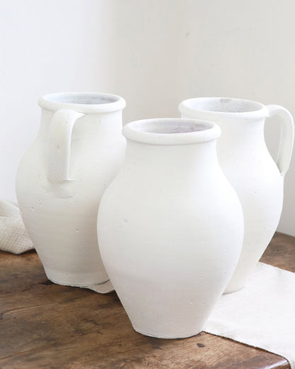 Grouping of chalk white jugs for dried stems