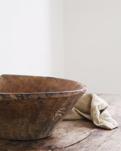 Hand carved finish of large wooden bowl on table top