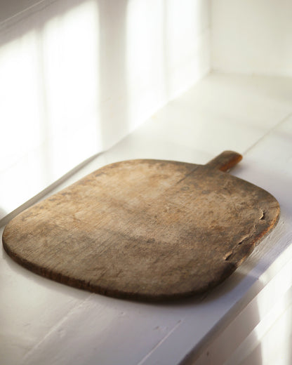 Dark wooden bread board for serving